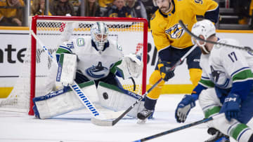 Apr 26, 2024; Nashville, Tennessee, USA; Vancouver Canucks goaltender Casey DeSmith (29) blocks the deflection of Nashville Predators left wing Filip Forsberg (9) during the third period in game three of the first round of the 2024 Stanley Cup Playoffs at Bridgestone Arena. Mandatory Credit: Steve Roberts-USA TODAY Sports