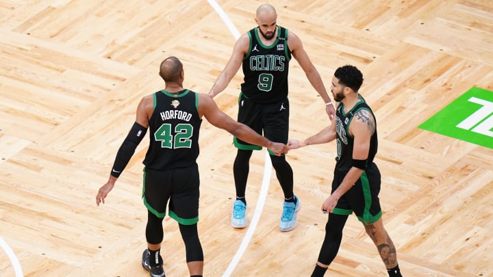 Boston Celtics center Al Horford (42) and guard Derrick White (9) and forward Jayson Tatum (0) celebrate.