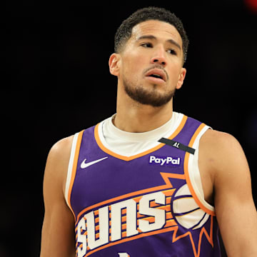 Apr 8, 2025; Phoenix, Arizona, USA; Phoenix Suns guard Devin Booker (1) reacts against the Golden State Warriors during the second half at Footprint Center. Mandatory Credit: Mark J. Rebilas-Imagn Images