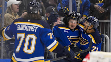 Mar 25, 2025; St. Louis, Missouri, USA;  St. Louis Blues center Alexandre Texier (9) is congratulated by right wing Mathieu Joseph (71) and center Oskar Sundqvist (70) after scoring against the Montreal Canadiens during the second period at Enterprise Center. Mandatory Credit: Jeff Curry-Imagn Images