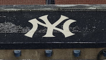 Aug 17, 2020; Bronx, New York, USA; A general view of rain falling on the  New York Yankees logo on the first base dugout roof during a rain delay in the game between the New York Yankees and the Boston Red Sox. Mandatory Credit: Vincent Carchietta-Imagn Images