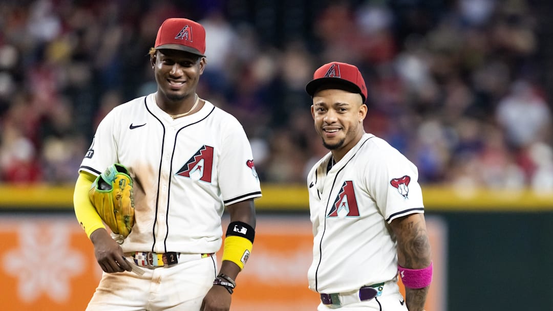 Aug 19, 2025; Phoenix, Arizona, USA; Arizona Diamondbacks infielder Geraldo Perdomo (left) with Ketel Marte against the Cleveland Guardians at Chase Field. Mandatory Credit: Mark J. Rebilas-Imagn Images
