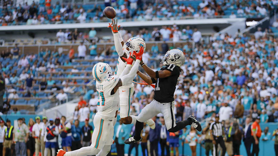 Miami Dolphins cornerback Jalen Ramsey (5) intercepts a pass intended to Las Vegas Raiders wide receiver Tre Tucker (11) during the fourth quarter at Hard Rock Stadium. | Sam Navarro-Imagn Images