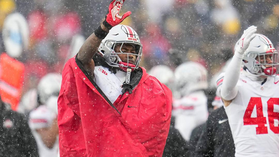 Ohio State Buckeyes wide receiver Jeremiah Smith (4) waves as Michigan Wolverines fans stream out of the gates in the fourth quarter of the NCAA football game at Michigan Stadium in Ann Arbor, Mich. on Nov. 29, 2025. Ohio State won 27-9.
