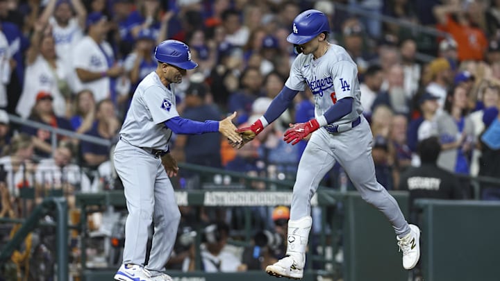 Jul 27, 2024; Houston, Texas, USA; Los Angeles Dodgers first baseman Cavan Biggio (6) celebrates with third base coach Dino Ebel (91) after hitting a home run during the eighth inning against the Houston Astros at Minute Maid Park.