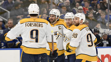 Dec 27, 2024; St. Louis, Missouri, USA; Nashville Predators center Steven Stamkos (91) is congratulated by teammates after scoring a goal against the St. Louis Blues during the first period at Enterprise Center. Mandatory Credit: Jeff Le-Imagn Images
