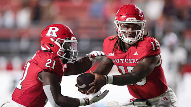 Rutgers Scarlet Knights quarterback Ajani Sheppard (15) looks to hand off to running back Antwan Raymond (21) during the seco