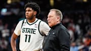 Michigan State guard Jase Richardson (11) watches with coach Tom Izzo during the Big Ten Tournament in Indianapolis.