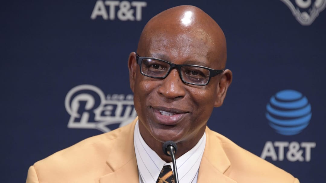 Former SMU Mustangs running back Eric Dickerson wears a Pro Football Hall of Fame gold jacket during a press conference after signing a one-day contract to retire as a member of the Los Angeles Rams at Cal Lutheran University.