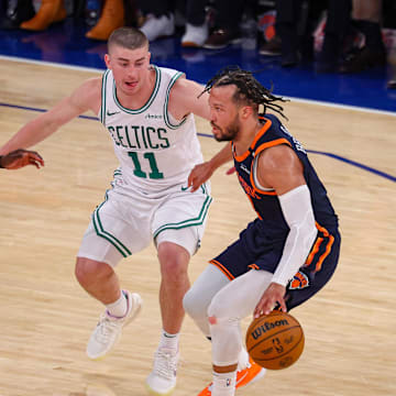 May 12, 2025; New York, New York, USA; New York Knicks guard Jalen Brunson (11) dribbles against Boston Celtics guard Payton Pritchard (11) and Jrue Holiday (4) in the second half during game four of the second round for the 2025 NBA Playoffs at Madison Square Garden. Mandatory Credit: Vincent Carchietta-Imagn Images