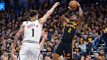 May 5, 2025; Oklahoma City, Oklahoma, USA; Oklahoma City Thunder guard Shai Gilgeous-Alexander (2) shoots as Denver Nuggets forward Michael Porter Jr. (1) defends during the second half during game one of the second round for the 2025 NBA Playoffs at Paycom Center. Mandatory Credit: Alonzo Adams-Imagn Images