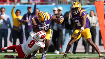 Jan 1, 2024; Tampa, FL, USA;  LSU Tigers running back Kaleb Jackson (28) scores a touchdown against the Wisconsin Badgers in the second quarter during the ReliaQuest Bowl at Raymond James Stadium. Mandatory Credit: Nathan Ray Seebeck-USA TODAY Sports