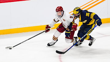 Apr 11, 2024; Saint Paul, Minnesota, USA; Boston College forward Ryan Leonard (9) protects the puck from Michigan defenseman Seamus Casey (26) in the semifinals of the 2024 Frozen Four college ice hockey tournament at Xcel Energy Center. Mandatory Credit: Brace Hemmelgarn-Imagn Images