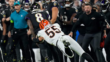Baltimore Ravens quarterback Lamar Jackson (8) is pulled down by Cincinnati Bengals linebacker Logan Wilson (55) in the first quarter of the NFL Week 11 game between the Baltimore Ravens and the Cincinnati Bengals at M&T Bank Stadium in Baltimore on Thursday, Nov. 16, 2023.
