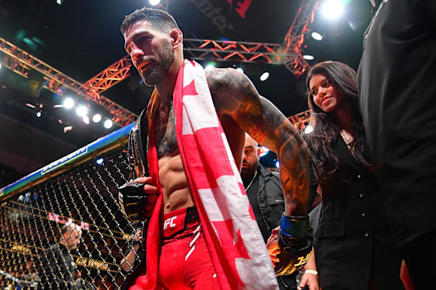 Ilia Topuria celebrates his championship victory against Alexander Volkanovski during UFC 298 at Honda Center. 