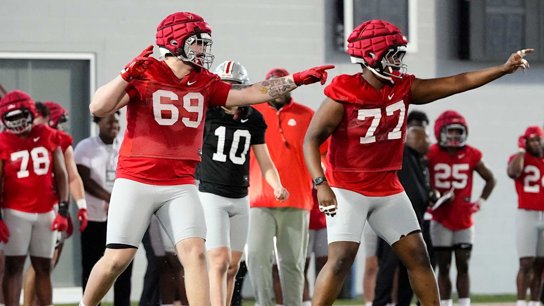 Ohio State Buckeyes offensive linemen Ian Moore (69) and Tegra Tshabola (77) motion during spring football practice at the Woody Hayes Athletic Center on March 17, 2025.