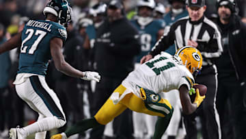 Jan 12, 2025; Philadelphia, Pennsylvania, USA; Green Bay Packers wide receiver Jayden Reed (11) makes a catch against Philadelphia Eagles cornerback Quinyon Mitchell (27) during the first half in an NFC wild card game at Lincoln Financial Field. Mandatory Credit: Bill Streicher-Imagn Images
