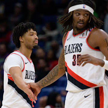 Jan 8, 2025; New Orleans, Louisiana, USA; Portland Trail Blazers guard Anfernee Simons (1) and center Robert Williams III (35) celebrate next to forward Kris Murray (24) during the first half against the New Orleans Pelicans at Smoothie King Center. Mandatory Credit: Matthew Hinton-Imagn Images