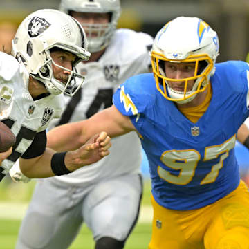 Sep 8, 2024; Inglewood, California, USA; Las Vegas Raiders quarterback Gardner Minshew (15) is sacked by Los Angeles Chargers linebacker Joey Bosa (97) in the second half at SoFi Stadium. Mandatory Credit: Jayne Kamin-Oncea-Imagn Images