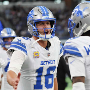 Detroit Lions wide receiver Jameson Williams (9) celebrates with Detroit Lions quarterback Jared Goff (16) 