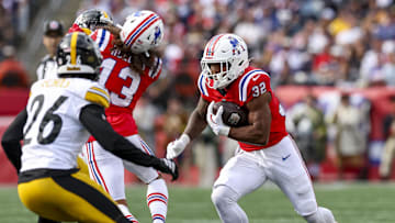 Sep 21, 2025; Foxborough, Massachusetts, USA; New England Patriots running back Treveyon Henderson (32) runs the ball during the third quarter at Gillette Stadium. Mandatory Credit: Paul Rutherford-Imagn Images