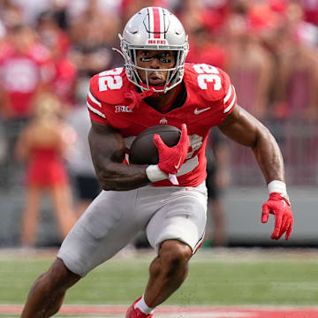 Aug 31, 2024; Columbus, OH, USA; Ohio State Buckeyes running back TreVeyon Henderson (32) runs upfield during the NCAA football game against the Akron Zips at Ohio Stadium. Ohio State won 52-6.