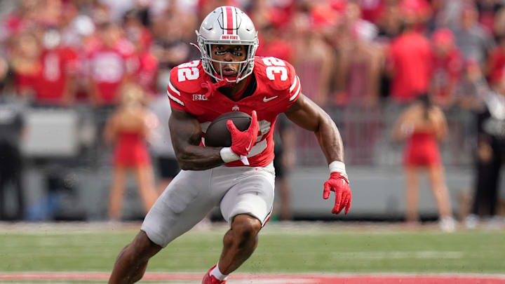 Aug 31, 2024; Columbus, OH, USA; Ohio State Buckeyes running back TreVeyon Henderson (32) runs upfield during the NCAA football game against the Akron Zips at Ohio Stadium. Ohio State won 52-6.