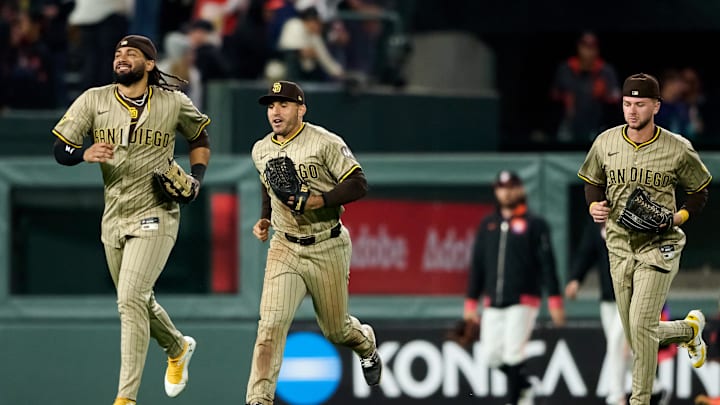 Aug 12, 2025; San Francisco, California, USA; San Diego Padres outfielders Fernando Tatis Jr. (23), Ramon Laureano (5) and Jackson Merrill (3) run in from the outfield after defeating the San Francisco Giants in the ninth inning at Oracle Park. Mandatory Credit: Robert Edwards-Imagn Images Aug 12, 2025; San Francisco, California, USA; San Diego Padres outfielders Fernando Tatis Jr. (23), Ramon Laureano (5) and Jackson Merrill (3) run in from the outfield after defeating the San Francisco Giants in the ninth inning at Oracle Park. Mandatory Credit: Robert Edwards-Imagn Images