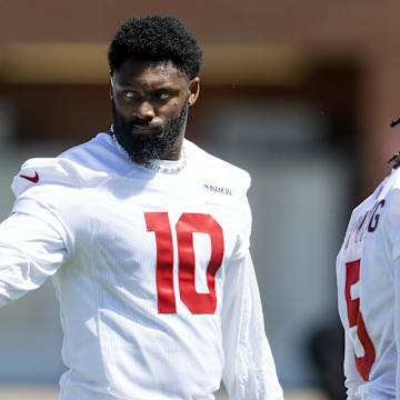 Jun 10, 2025; Tempe, AZ, USA; Arizona Cardinals linebacker Josh Sweat (10) shares water with a teammate during minicamp at the teams Arizona Cardinals Training Facility. Mandatory Credit: Mark J. Rebilas-Imagn Images