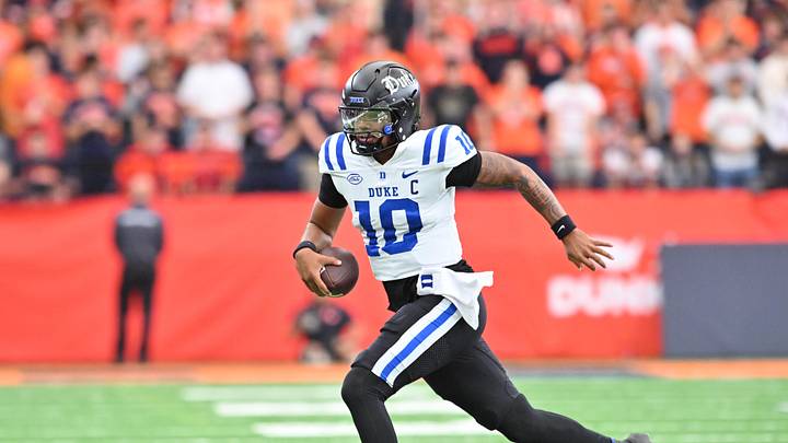 Sep 27, 2025; Syracuse, New York, USA; Duke Blue Devils quarterback Darian Mensah (10) runs out of the pocket in the second quarter against the Syracuse Orange.