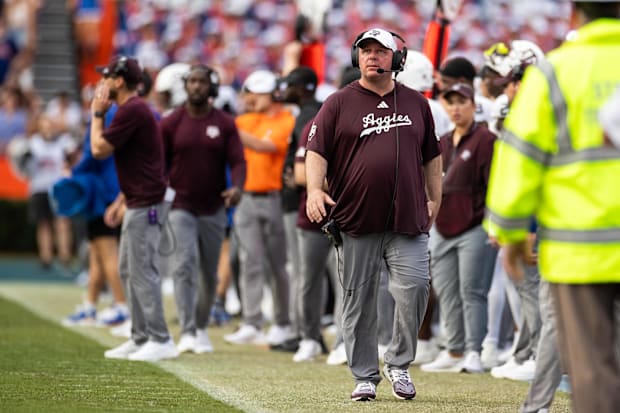 Texas A&M Aggies head coach Mike Elko walks the sideline against the Florida Gators during the first half at Ben Hill Griffin