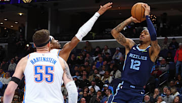 Mar 5, 2025; Memphis, Tennessee, USA; Memphis Grizzlies guard Ja Morant (12) shoots as Oklahoma City Thunder guard Shai Gilgeous-Alexander (2) defends during the third quarter at FedExForum. Mandatory Credit: Petre Thomas-Imagn Images