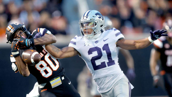 Oct 6, 2023; Stillwater, Oklahoma, USA; Kansas State player Marques Sigle (21) breaks up a pass intended for Oklahoma State player Brennan Presley (80) in the first half of the college football game between the Oklahoma State University Cowboys and the Kansas State Wildcats at Boone Pickens Stadium. Mandatory Credit: Sarah Phipps-USA TODAY Sports