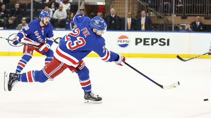 Apr 17, 2025; New York, New York, USA;  New York Rangers defenseman Adam Fox (23) attempts a shot on goal in the first period against the Tampa Bay Lightning at Madison Square Garden. Mandatory Credit: Wendell Cruz-Imagn Images