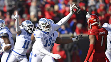 Nov 25, 2023; Louisville, Kentucky, USA;  Kentucky Wildcats linebacker J.J. Weaver (13) celebrates a fumble recovery during the second half against the Louisville Cardinals at L&N Federal Credit Union Stadium. Kentucky defeated Louisville 38-31. Mandatory Credit: Jamie Rhodes-Imagn Images