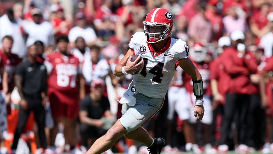Georgia Bulldogs quarterback Gunner Stockton runs with the ball against the Arkansas Razorbacks.