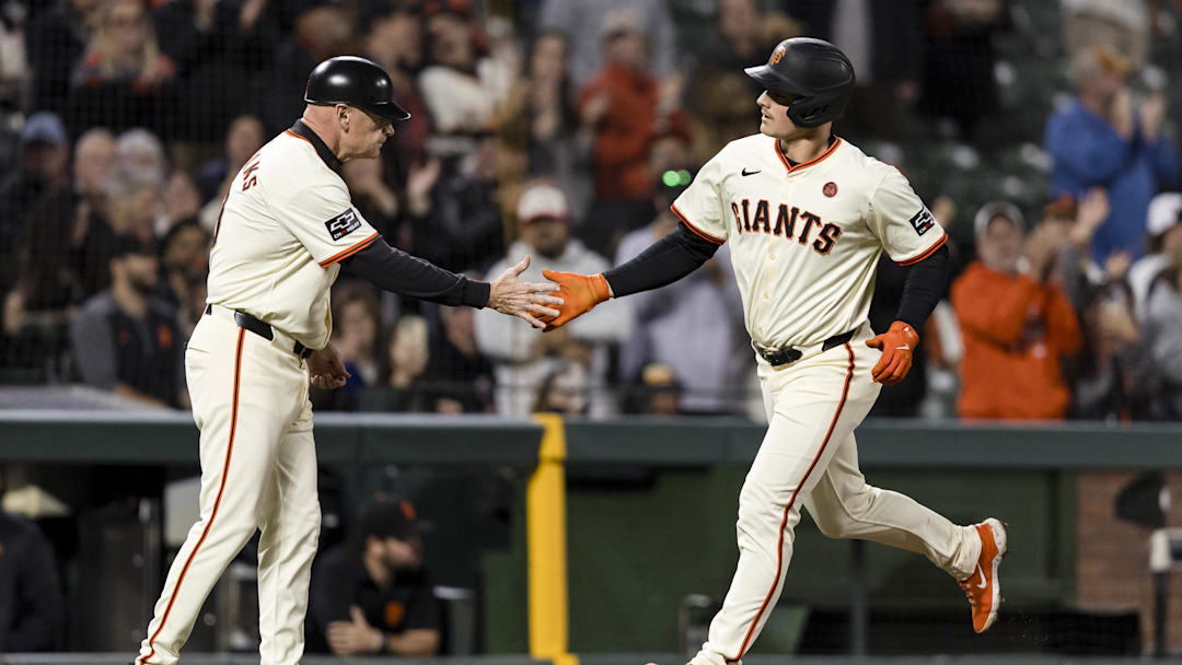 Sep 11, 2024; San Francisco, California, USA; San Francisco Giants third baseman Matt Chapman (26) is congratulated by third base coach Matt Williams (9) after he hit a solo home run against the Milwaukee Brewers during the fourth inning at Oracle Park. 