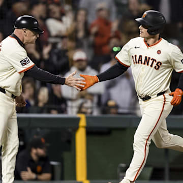 Sep 11, 2024; San Francisco, California, USA; San Francisco Giants third baseman Matt Chapman (26) is congratulated by third base coach Matt Williams (9) after he hit a solo home run against the Milwaukee Brewers during the fourth inning at Oracle Park. 