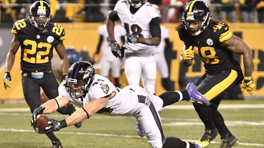 Dec 25, 2016; Pittsburgh, PA, USA; Baltimore Ravens fullback Kyle Juszczyk (44) stretches the ball across the goal line to score a touchdown as Pittsburgh Steelers cornerback William Gay (22) and outside linebacker Bud Dupree (48) react in the fourth quarter of a game at Heinz Field. Pittsburgh won 31-27. Mandatory Credit: Mark Konezny-Imagn Images