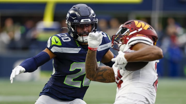 Nov 12, 2023; Seattle, Washington, USA; Seattle Seahawks safety Julian Love (20) tackles Washington Commanders running back Antonio Gibson (24) during the second quarter at Lumen Field.