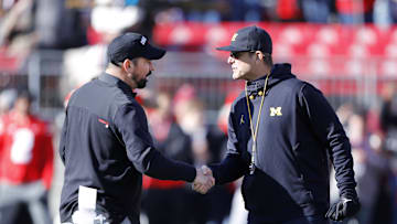 Nov 26, 2022; Columbus, Ohio, USA; Michigan Wolverines head coach Jim Harbaugh (right) and Ohio State Buckeyes head coach Ryan Day (left) shake hands before the game at Ohio Stadium. Mandatory Credit: Joseph Maiorana-Imagn Images