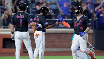 Aug 15, 2025; New York City, New York, USA; New York Mets catcher Francisco Alvarez (4) celebrates his three run home run against the Seattle Mariners with center fielder Cedric Mullins (28) and second baseman Jeff McNeil (1) during the eighth inning at Citi Field. Mandatory Credit: Brad Penner-Imagn Images