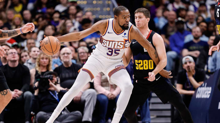 Mar 27, 2024; Denver, Colorado, USA; Phoenix Suns forward Kevin Durant (35) controls the ball as Denver Nuggets guard Collin Gillespie (21) guards in the second quarter at Ball Arena. Mandatory Credit: Isaiah J. Downing-USA TODAY Sports