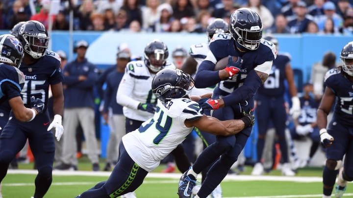 Dec 24, 2023; Nashville, Tennessee, USA; Tennessee Titans running back Derrick Henry (22) is tackled by Seattle Seahawks linebacker Bobby Wagner (54) after a short gain during the second half at Nissan Stadium. Mandatory Credit: Christopher Hanewinckel-USA TODAY Sports