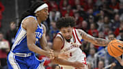 Dec 8, 2024; Louisville, Kentucky, USA;  Louisville Cardinals guard J'Vonne Hadley (1) dribbles against Duke Blue Devils forward Maliq Brown (6) during the second half at KFC Yum! Center. Duke defeated Louisville 76-65. Mandatory Credit: Jamie Rhodes-Imagn Images