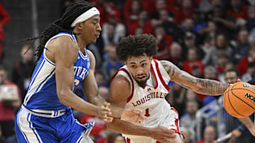 Dec 8, 2024; Louisville, Kentucky, USA;  Louisville Cardinals guard J'Vonne Hadley (1) dribbles against Duke Blue Devils forward Maliq Brown (6) during the second half at KFC Yum! Center. Duke defeated Louisville 76-65. Mandatory Credit: Jamie Rhodes-Imagn Images
