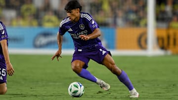 Aug 23, 2025; Nashville, Tennessee, USA;  Orlando City forward Ramiro Enrique (7) dribbles the ball against the Nashville SC during the first half at Geodis Park. Mandatory Credit: Steve Roberts-Imagn Images