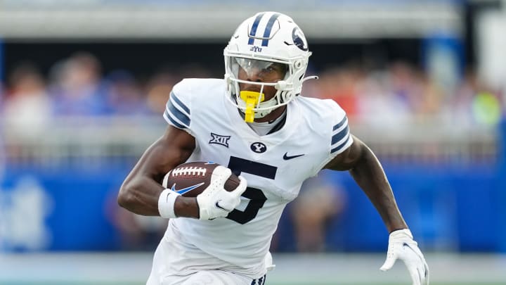 Sep 23, 2023; Lawrence, Kansas, USA; Brigham Young Cougars wide receiver Darius Lassiter (5) runs with the ball during the second half against the Kansas Jayhawks at David Booth Kansas Memorial Stadium.