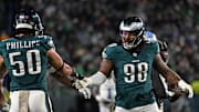 Nov 16, 2025; Philadelphia, Pennsylvania, USA;  Philadelphia Eagles defensive tackle Jalen Carter (98) celebrates a stop with linebacker Jaelan Phillips (50) against the Detroit Lions at Lincoln Financial Field. Mandatory Credit: Eric Hartline-Imagn Images