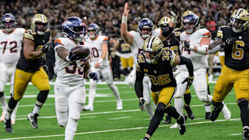 Oct 17, 2024; New Orleans, Louisiana, USA; Denver Broncos running back Javonte Williams (33) scores a touchdown against New Orleans Saints safety Tyrann Mathieu (32) during the second quarter at Caesars Superdome. Mandatory Credit: Matthew Hinton-Imagn Images